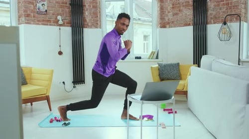 Young Adult Exercising Doing Lunges at Home