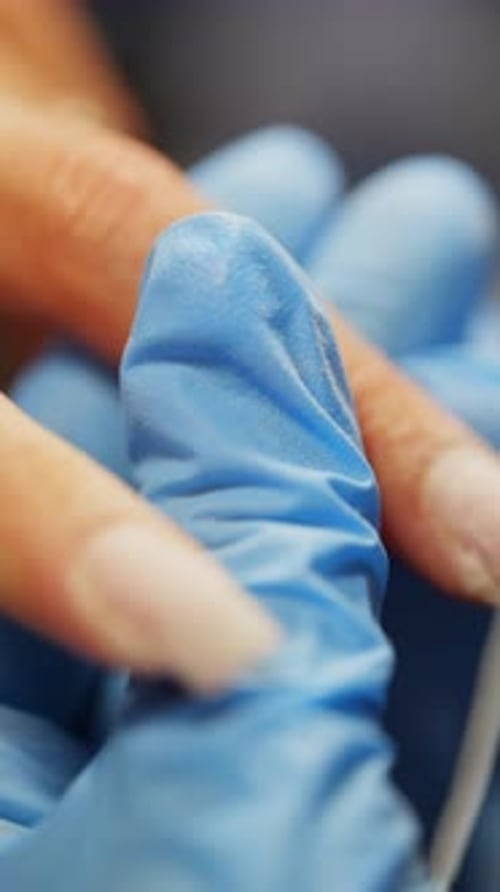Manicurist Applying Acrylic to Nail in Close Up
