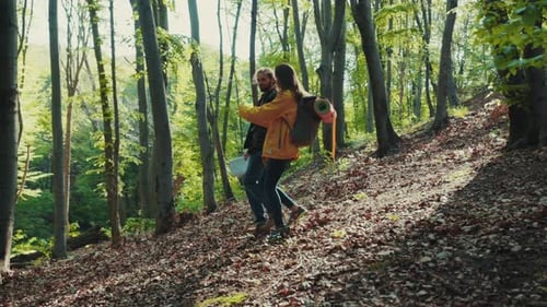 Young Travelers with Backpacks Walk Down the Path in Woods Active Lifestyle Joy of Life Partnership
