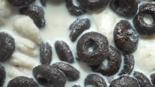 Chocolate Cereal Mixed with Milk in a Bowl Top View