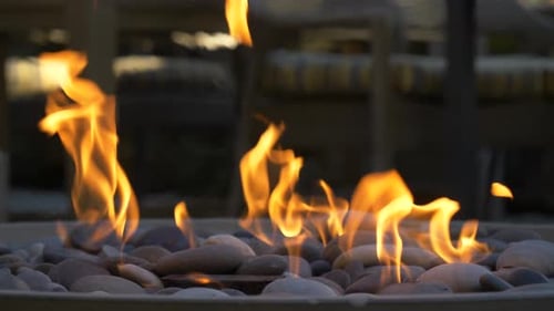 Warm fire pit with decorative rocks at night