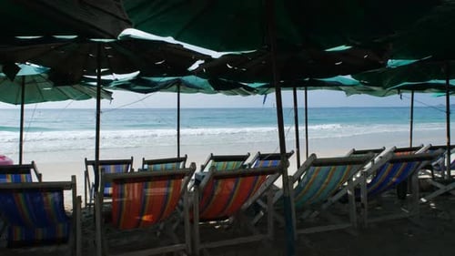 Empty Sun Loungers and Umbrellas Near Beach