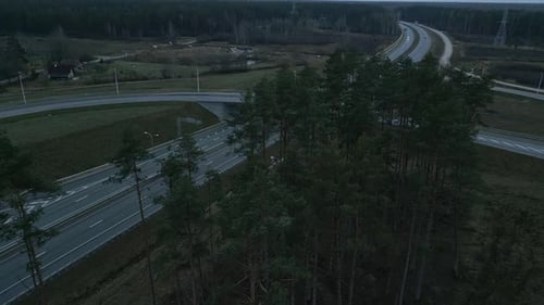 Captivating Aerial View Showcasing Serene Highway Curves Surrounded By a Scenic Landscape During