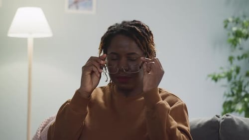 Woman Puts On Glasses and Smiles Inside