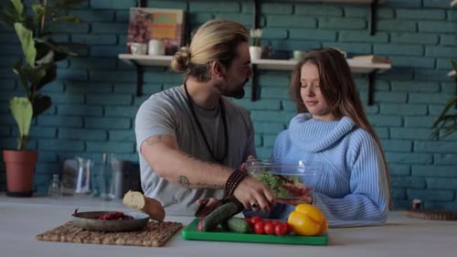 Couple Prepares Salad in Home Kitchen Together