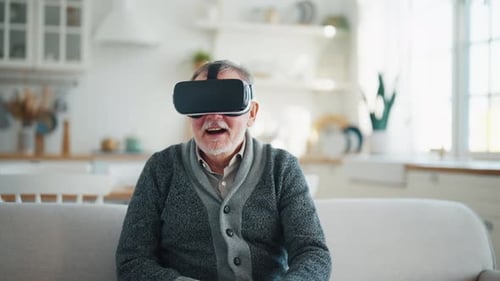 Senior Man Experiencing Virtual Reality in Home
