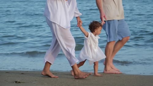 Walking with a Child on the Beach Family on Vacation By the Ocean Walking Along the Sand of the