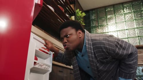 Young Adult Grabbing Ingredients From Refrigerator