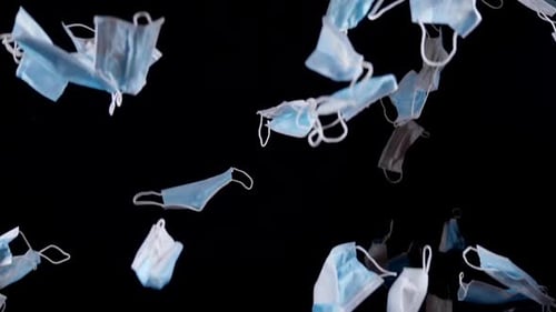 Floating Medical Face Masks on Black Background