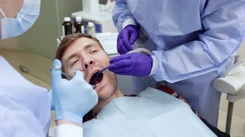 Dentist Applies an Injection of Anesthetic with a Syringe in a Dental Clinic Dental Treatment