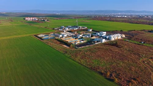 Vast green fields surround the territory of the modern water treatment plant.