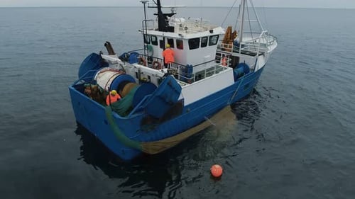 Fishing Boat Deploying Nets in the Open Ocean