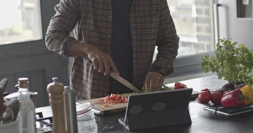 Man Cooking Vegetables in Bright Home Kitchen