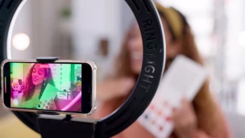 Woman, makeup influencer and smartphone with ring light for live streaming