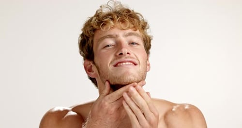 Face, beard and man with cosmetics, skincare and dermatology on studio background