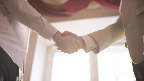 Close Up of Men Shaking Hands in Office