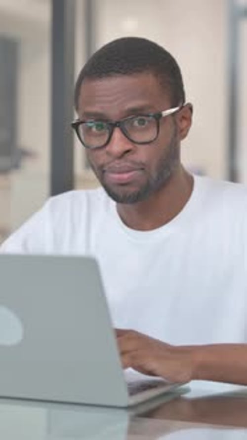 Smiling African American Man Looking at Camera in Office, vertical video