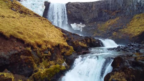 Scenic Waterfall Cascading Through Rocky Landscape