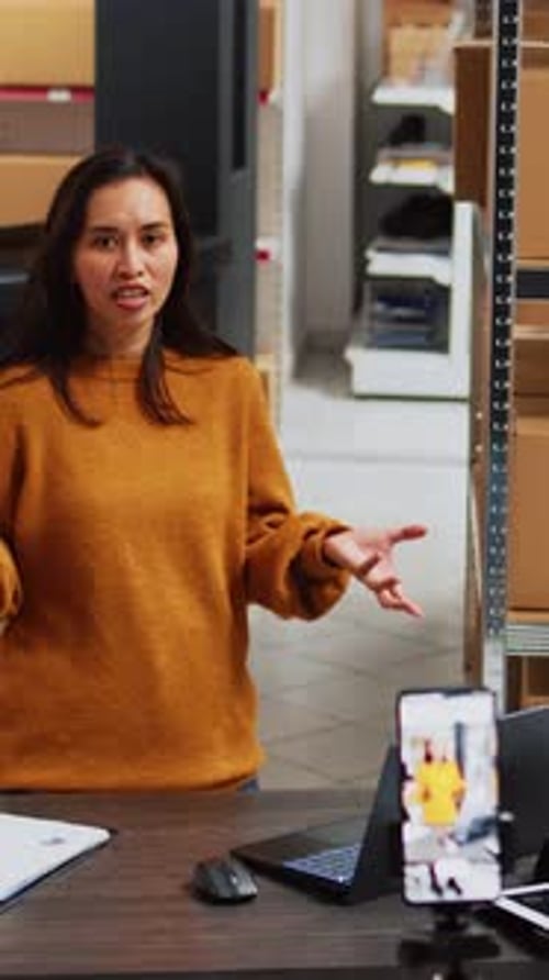 Woman Presents Warehouse Logistics on Smartphone