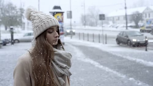 Young Beautiful Sad Girl Standing in the City, Winter Time 20s