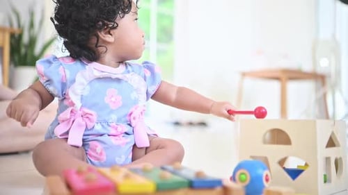 Baby Girl Playing with Toys at Home