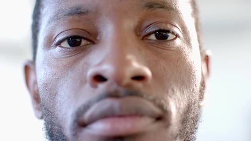 Close-up of an African American man with a beard and thoughtful expression