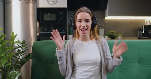 Enthusiastic Woman Dancing, Listening to Music Indoors