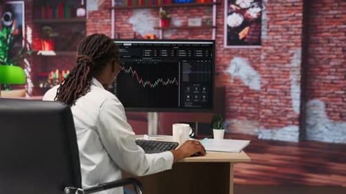 Woman Works with Financial Data in Home Office