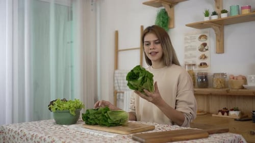 Woman Preparing Fresh Lettuce in Bright Kitchen