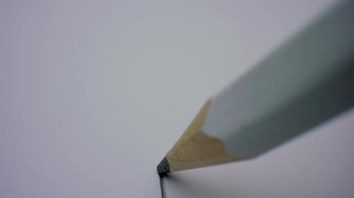 Pencil Drawing a Black Line on White Paper