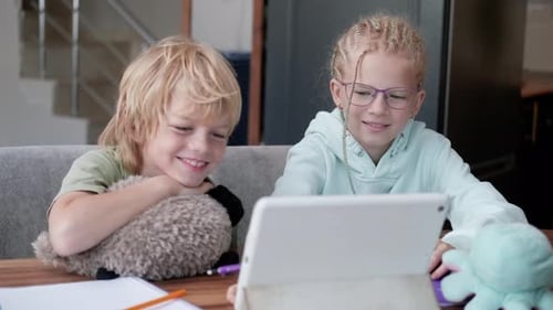 Online School Class Siblings Pupils Boy and Girl Learning Together Remotely Online at Home Looking