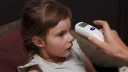 Little Girl Doesn't Want Her Temperature to Be Measured By a Forehead Thermometer