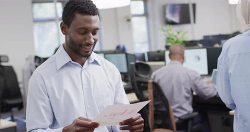 Portrait of happy african american businessman working with colleagues in office, slow motion