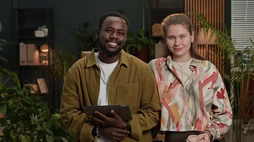 Portrait of Biracial Zoomers with Tablet Working at Office Space with Plants