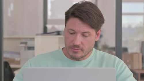 Close up of Man Working on Laptop