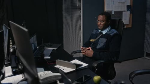 Security Guards Working Late Shift at Security Station