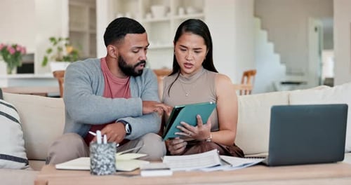 Adults Working Together on Tablet at Home