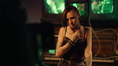 Alternative Fashion Model with Tattoos on Body Posing for Camera in Studio Filming Movie or Music