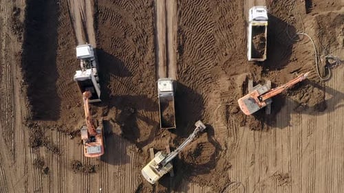Construction Vehicles Working in a Dirt Lot