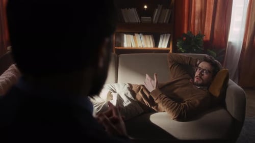 Man Lying on Couch Speaking with Therapist