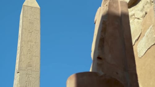 View of a Tall Obelisk in the Ancient City of Karnax with an Egyptian Statue of a Pharaoh