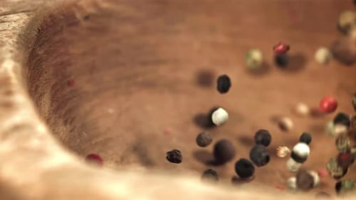 Peppercorn Falls Into a Wooden Bowl Filmed on a Highspeed Camera at 1000 Fps