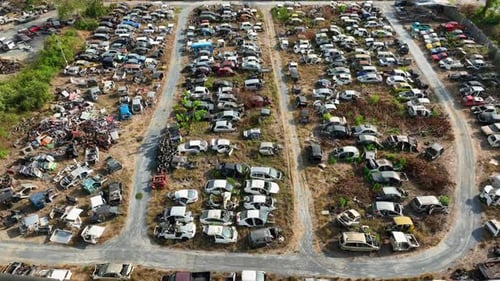 Drone aerial view showing of old vehicles in a salvage yard.