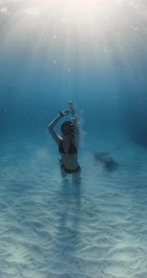 Woman Posing and Relaxing Underwater in Blue Ocean with Sun Rays Freediving in Sea with Sexy Woman