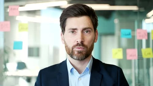 Webcam view. Businessman talking on a video call looking at camera sitting in office