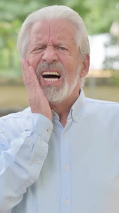 Senior Man Experiencing Sudden and Intense Tooth Pain