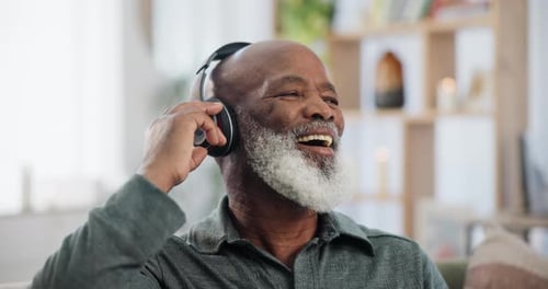 Man Listening to Music on Headphones Indoors