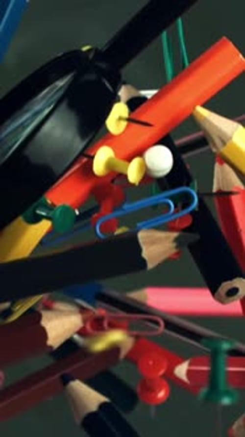 Different School Objects Fly and Fall Against the Background of the Blackboard Filmed on a Highspeed