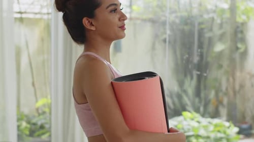 Tilt up Portrait of Young Sportswoman Training at Home with Yoga Mat