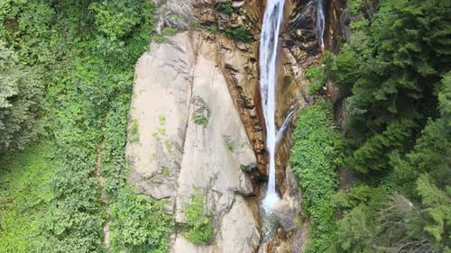 Scenic Waterfall Cascading Through Lush Green Forest